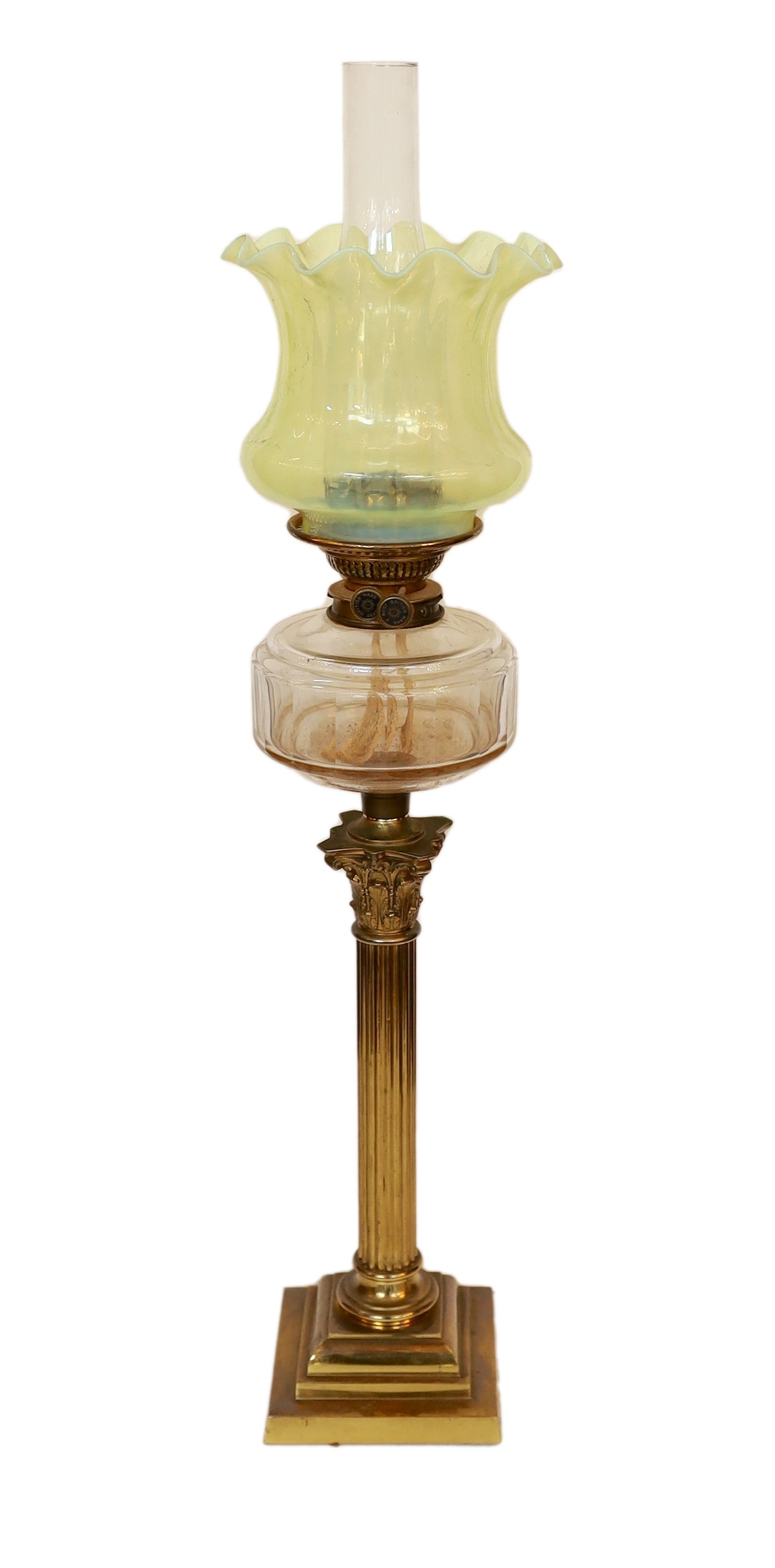 A late Victorian lacquered brass oil lamp with cut glass reservoir, Vaseline glass shade and flue, height overall 82cm